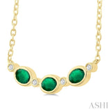 4X3MM Oval Cut Emerald and 1/50 Ctw Bezel Set Round Cut Diamond Precious Fashion Necklace in 10K Yellow Gold